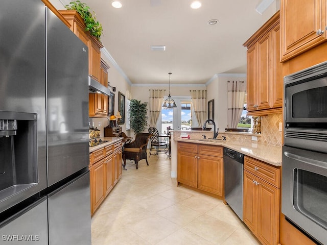 kitchen featuring hanging light fixtures, sink, ornamental molding, tasteful backsplash, and black appliances