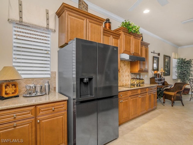 kitchen with light tile patterned floors, stainless steel fridge, ornamental molding, and decorative backsplash