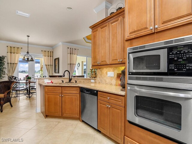 kitchen with light stone counters, stainless steel appliances, sink, ornamental molding, and light tile patterned floors