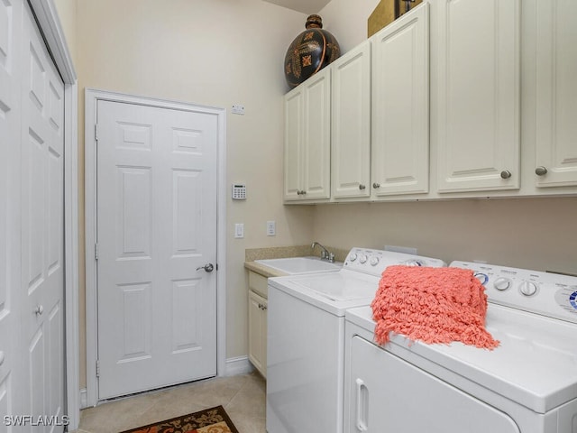 laundry room with separate washer and dryer, cabinets, sink, and light tile patterned flooring