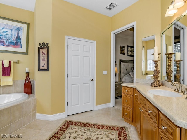 bathroom featuring vanity, tiled bath, and tile patterned floors