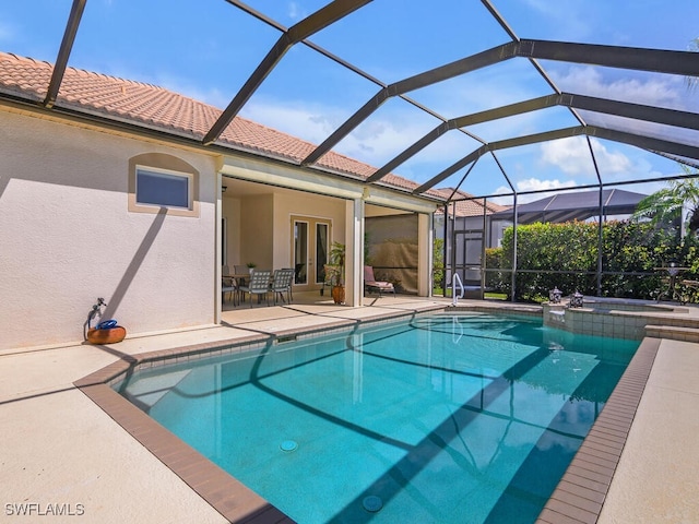 view of pool with a lanai and a patio