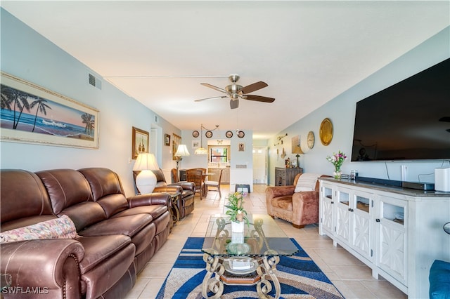 tiled living room with ceiling fan