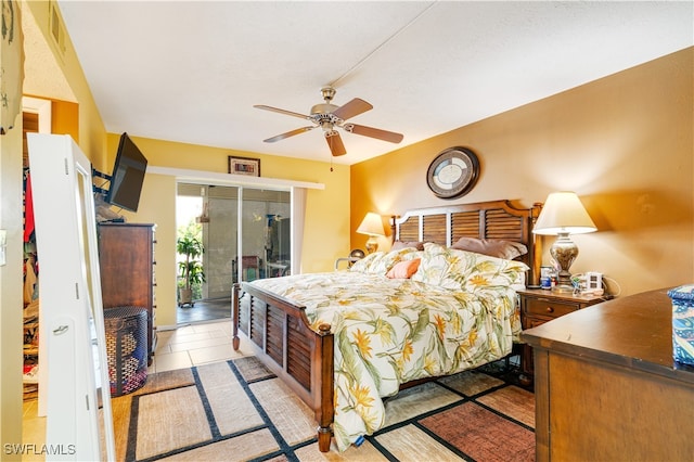 tiled bedroom with access to exterior and ceiling fan