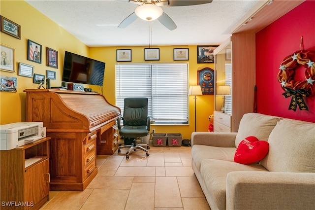 office space featuring light tile patterned flooring, ceiling fan, and a textured ceiling