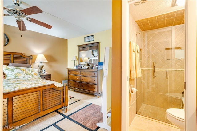 tiled bedroom featuring ceiling fan and connected bathroom