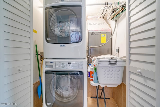 washroom featuring stacked washer / dryer