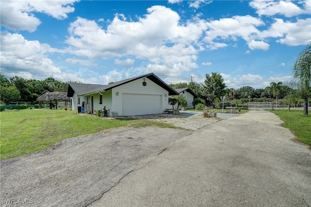 view of home's exterior with a garage and a yard