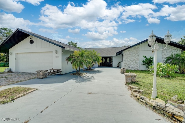 ranch-style home with a front yard and a garage