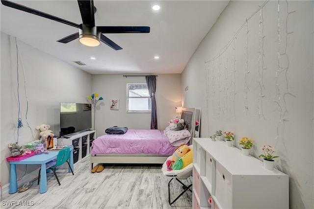 bedroom with light hardwood / wood-style floors and ceiling fan