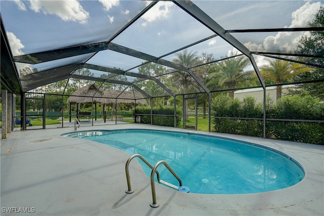 view of pool with a lanai and a patio area