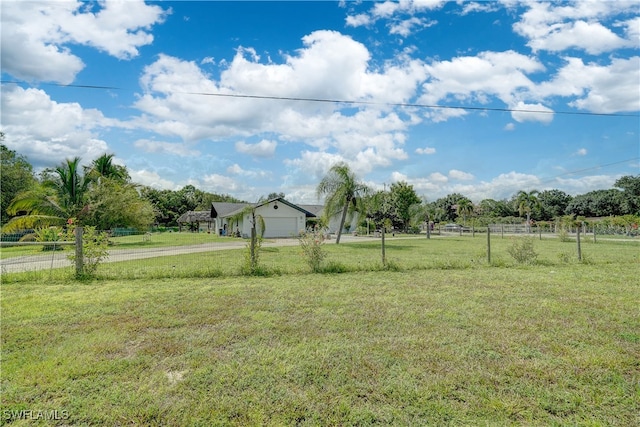 view of yard featuring a garage and a rural view