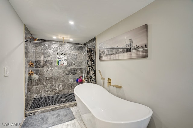 bathroom featuring shower with separate bathtub