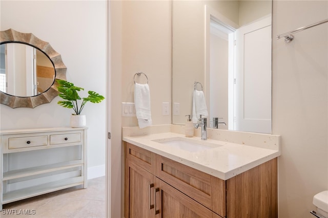 bathroom featuring vanity, toilet, and tile patterned flooring