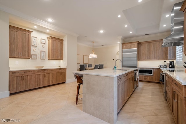 kitchen featuring sink, a spacious island, stainless steel appliances, extractor fan, and a breakfast bar