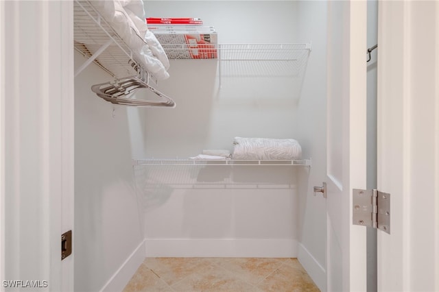 walk in closet featuring tile patterned flooring