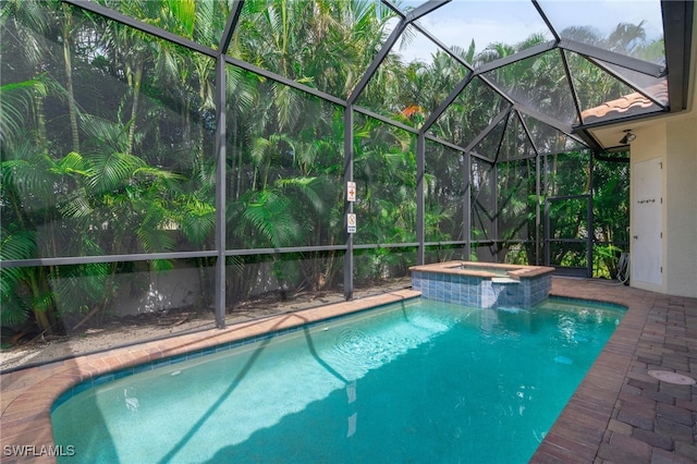 view of swimming pool with an in ground hot tub and glass enclosure