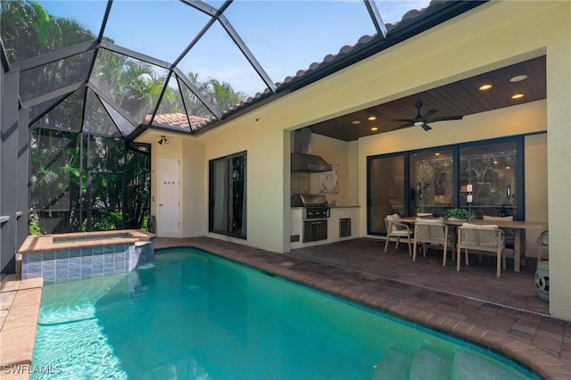 view of pool with area for grilling, an in ground hot tub, a patio, glass enclosure, and ceiling fan