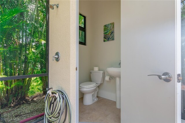 bathroom featuring tile patterned floors and toilet