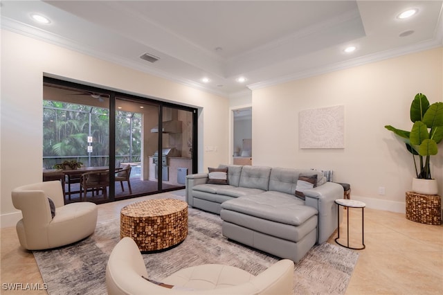 living room with crown molding, a raised ceiling, and light tile patterned flooring