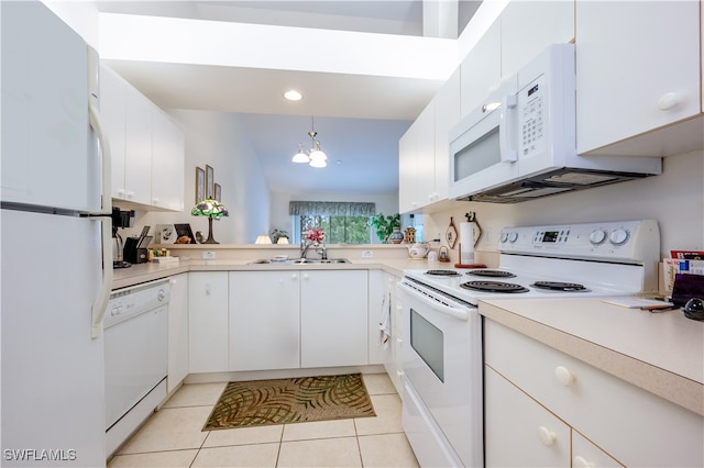 kitchen featuring light tile patterned flooring, sink, white appliances, and white cabinetry