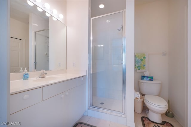 bathroom featuring walk in shower, vanity, toilet, and tile patterned floors