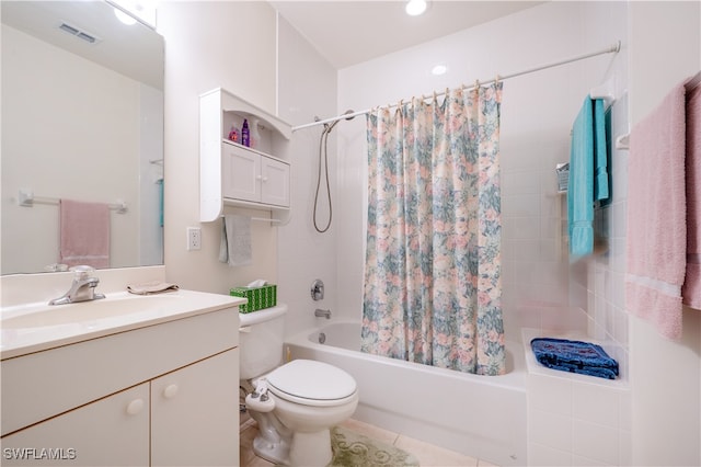 full bathroom featuring shower / bath combo with shower curtain, tile patterned floors, vanity, and toilet