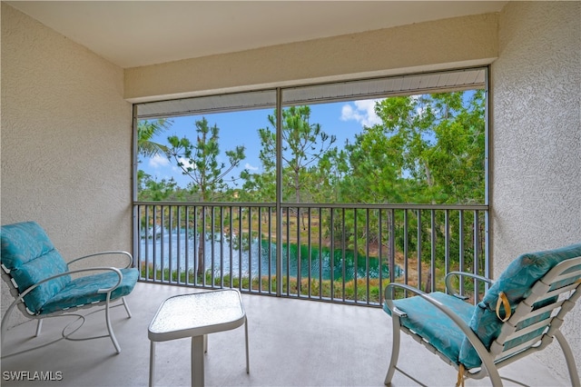 sunroom / solarium with a water view