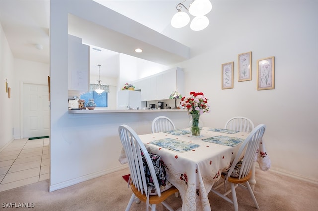 carpeted dining space featuring a notable chandelier