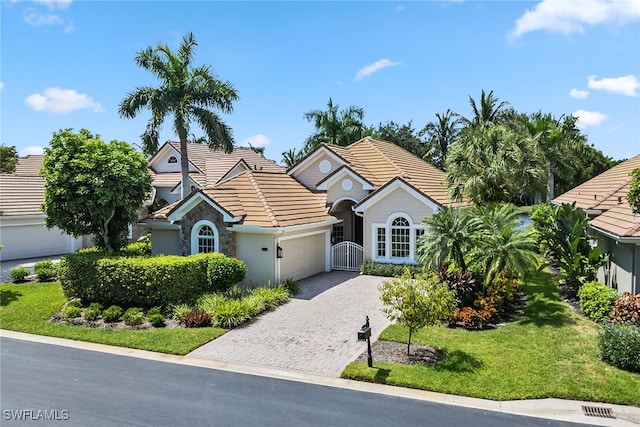 view of front of house featuring a garage and a front lawn