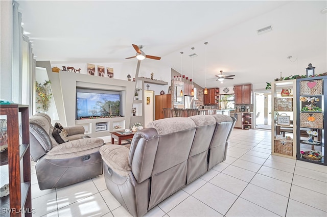 tiled living room with lofted ceiling and ceiling fan