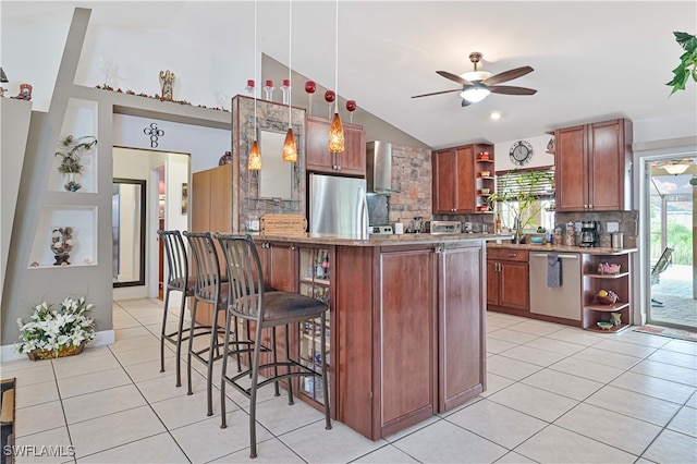 kitchen featuring pendant lighting, light tile patterned flooring, a breakfast bar area, stainless steel appliances, and ceiling fan