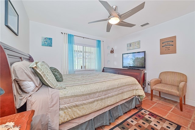 tiled bedroom featuring ceiling fan