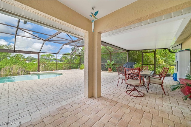 view of patio / terrace with pool water feature and glass enclosure