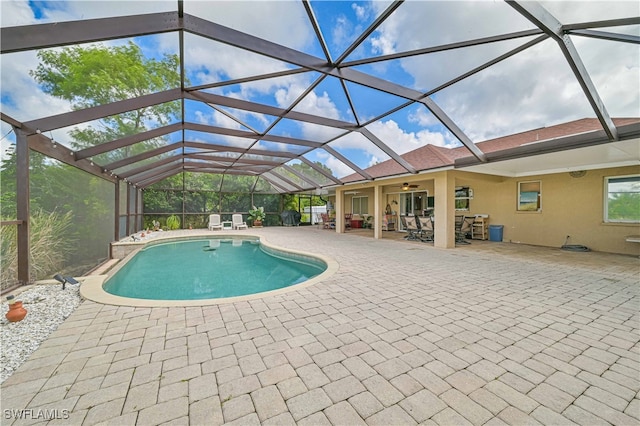 view of swimming pool with a patio and a lanai