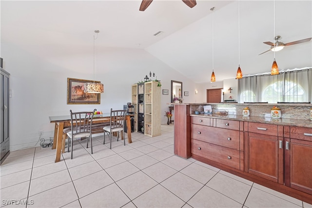 kitchen featuring high vaulted ceiling, light tile patterned flooring, ceiling fan, and decorative light fixtures