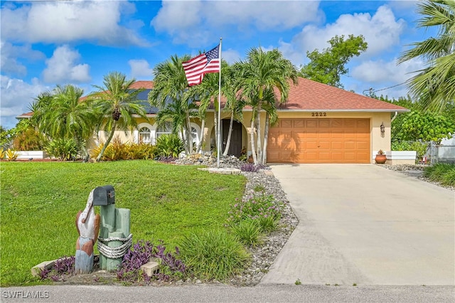 view of front facade with a garage and a front lawn