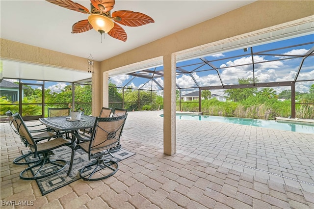 unfurnished sunroom with ceiling fan and a pool