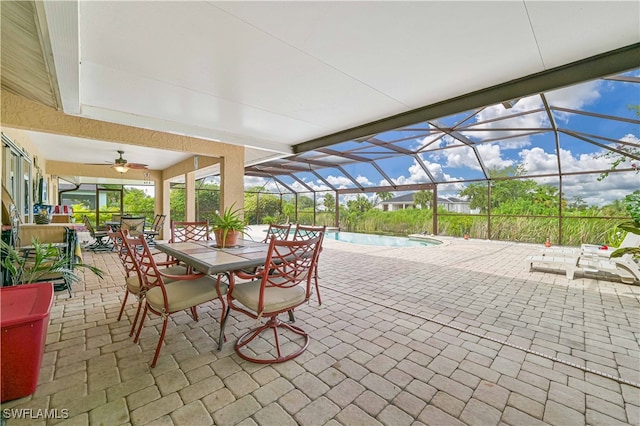 view of patio featuring glass enclosure and ceiling fan