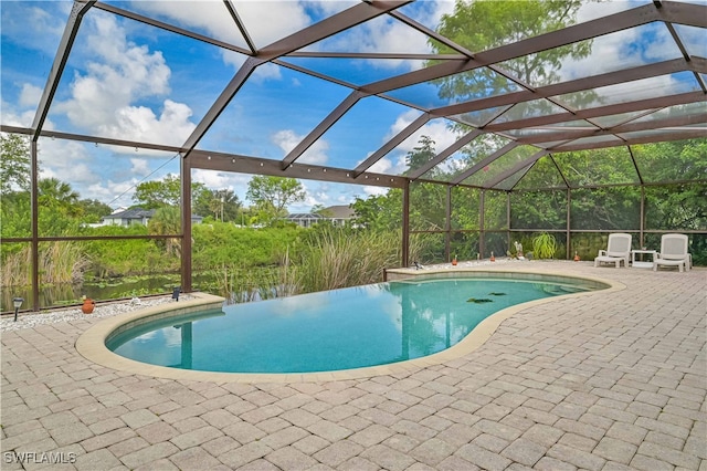 view of swimming pool featuring a water view, a patio, and glass enclosure