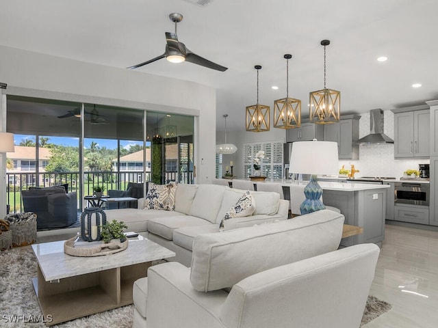 living room with ceiling fan with notable chandelier