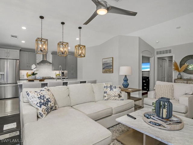 living room featuring ceiling fan with notable chandelier