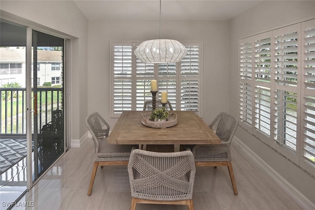 dining room with a notable chandelier and a wealth of natural light