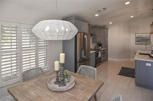 dining space featuring sink and light hardwood / wood-style floors