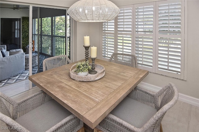 dining area featuring baseboards, a healthy amount of sunlight, french doors, and ceiling fan