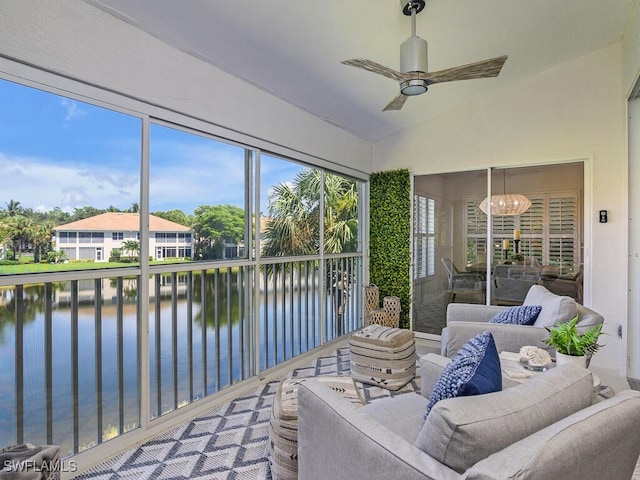sunroom / solarium featuring a chandelier and a water view