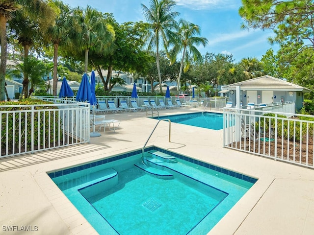 community pool featuring fence and a patio area