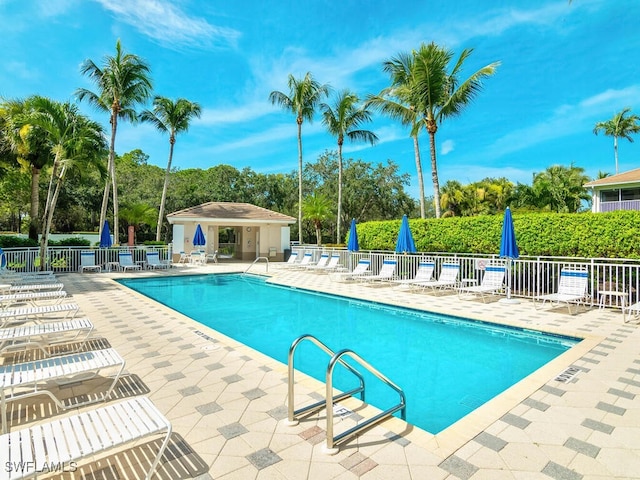 community pool featuring a patio area and fence