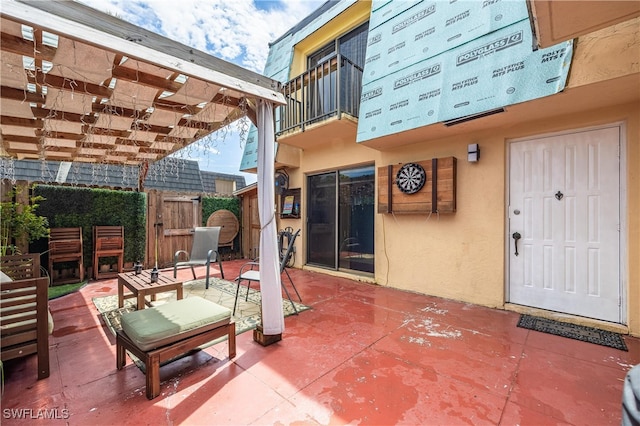 view of patio / terrace featuring a balcony and a pergola