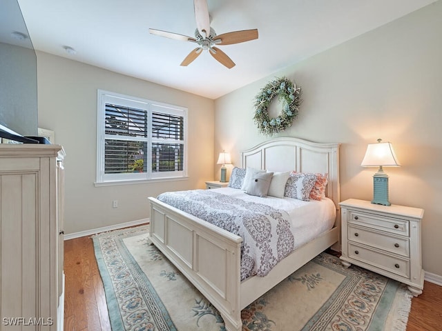 bedroom with ceiling fan and hardwood / wood-style flooring